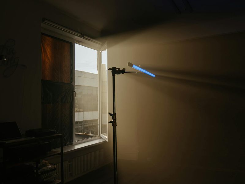 Spacious minimalist fitness studio with soft neon blue lighting.